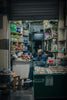 Elderly man smoking inside a small convenience store
