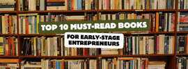 Bookshelves filled with recommended titles for early-stage entrepreneurs, highlighting the top 10 must-read books.