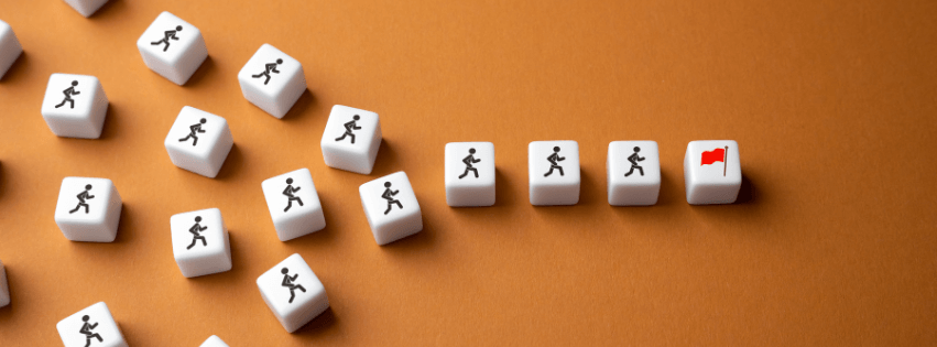 White dice with figures leading to a red flag, symbolizing goal-setting and progress in business.