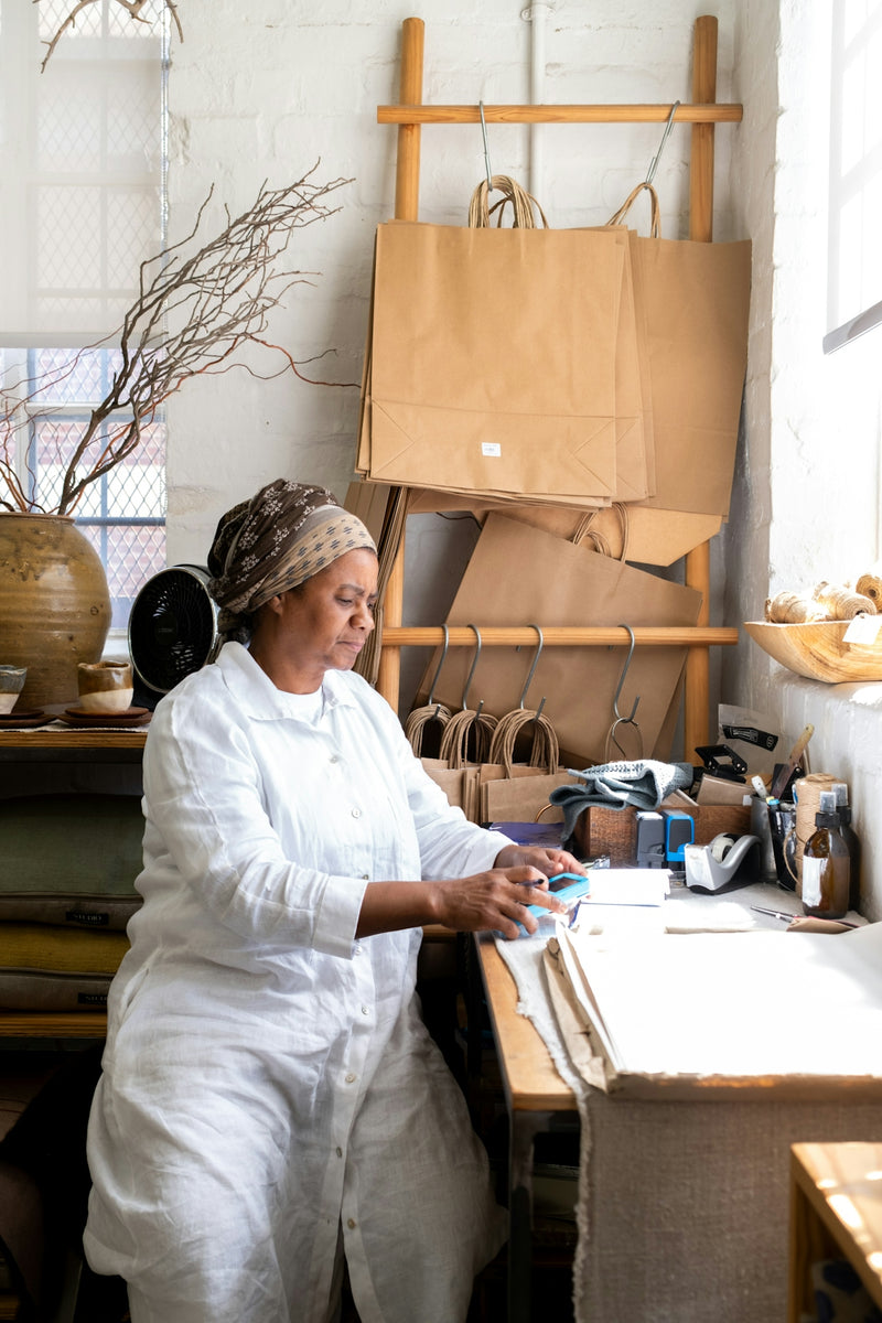 Woman working at a desk with craft supplies