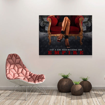 Girl Boss Building An Empire canvas wall art displayed above a chair, motivational gift for women entrepreneurs.