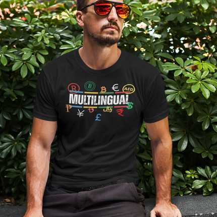 Multilingual Money T-Shirt – Speak Success in Every Language worn by a man in sunglasses amidst greenery.