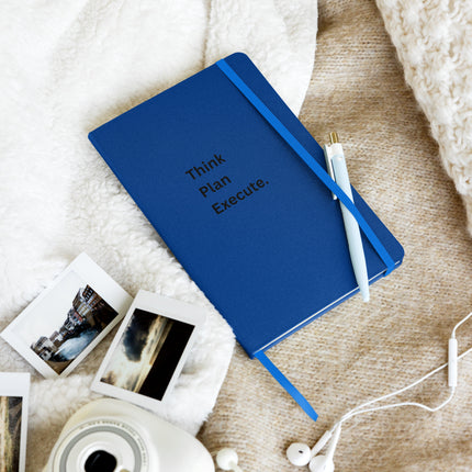 Think Plan Execute Journal – Strategic Notebook for Founders and Goal-Getters with blue cover and pen on textured surface.