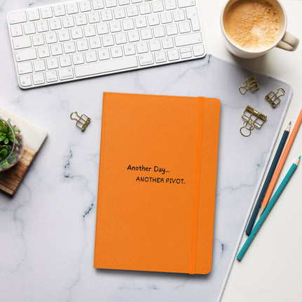 Another Day, Another Pivot Notebook – Agile Journal for Creative Entrepreneurs on a desk with a keyboard and coffee.