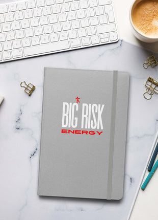 Big Risk Energy Notebook on a marble desk with stationery and coffee, perfect for visionaries and brainstorming.