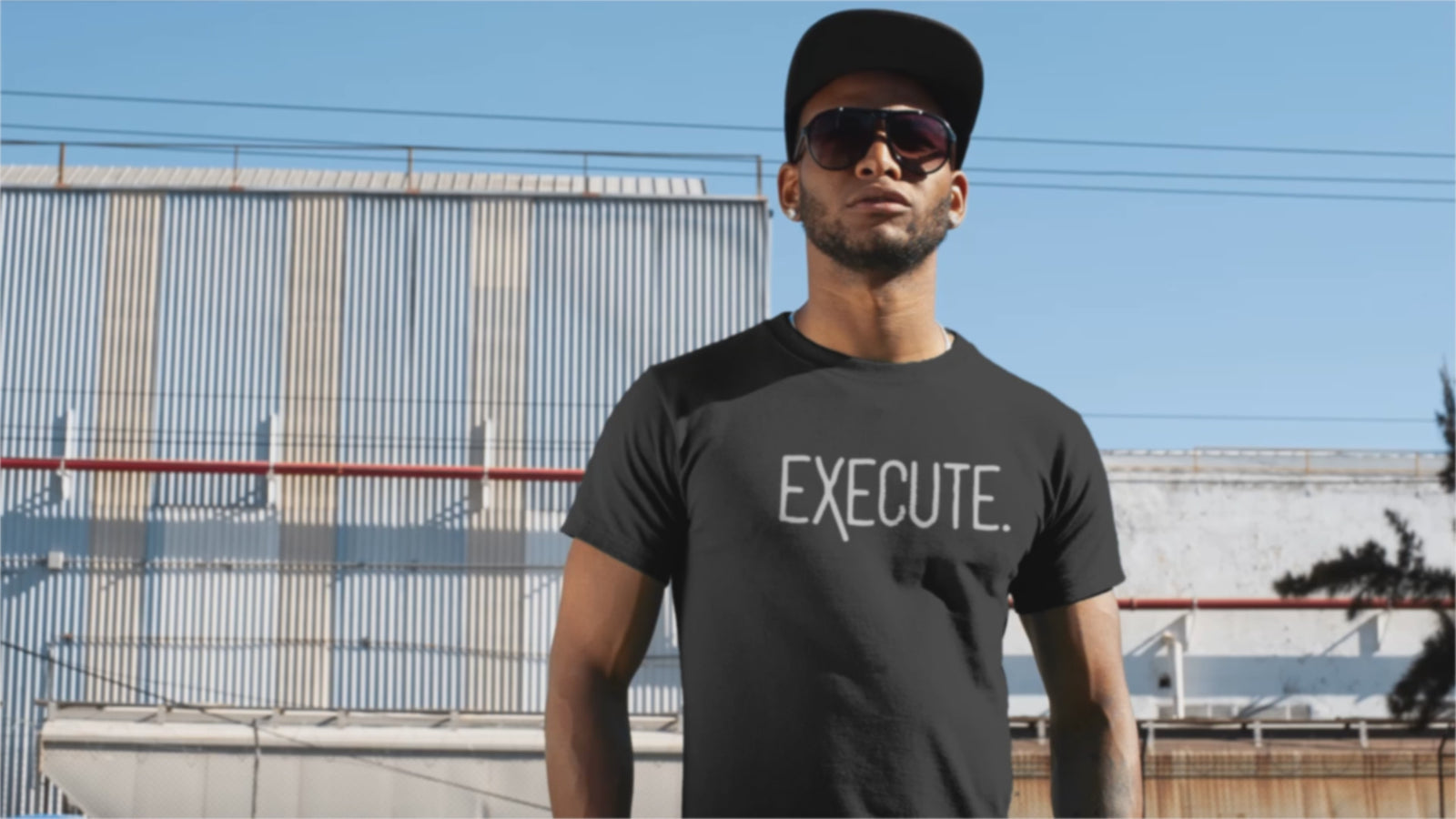 Man wearing EXECUTE T-Shirt, showcasing bold entrepreneur apparel for motivated individuals.