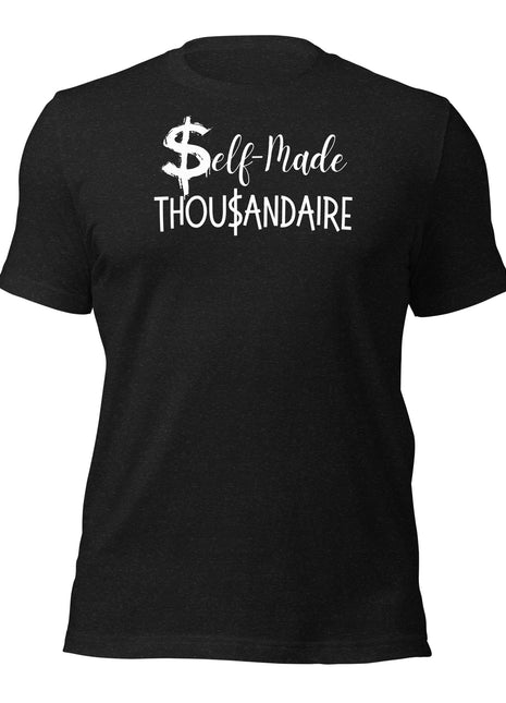 A black cotton t-shirt laid flat, featuring bold white text that reads “Self-Made Thousandaire” across the chest. The design is clean and minimal, making a powerful statement about entrepreneurial grit and financial independence.