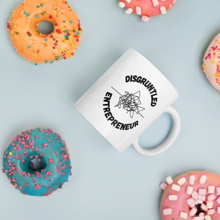 Disgruntled Entrepreneur Motivational Coffee Mug with colorful donuts in the background.
